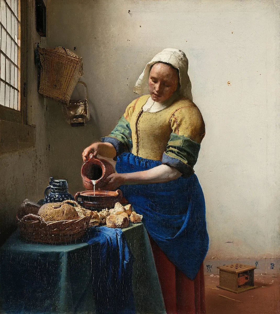 Vermeer painting of a maid pouring milk from a jug in a sunlit kitchen, bread on the table