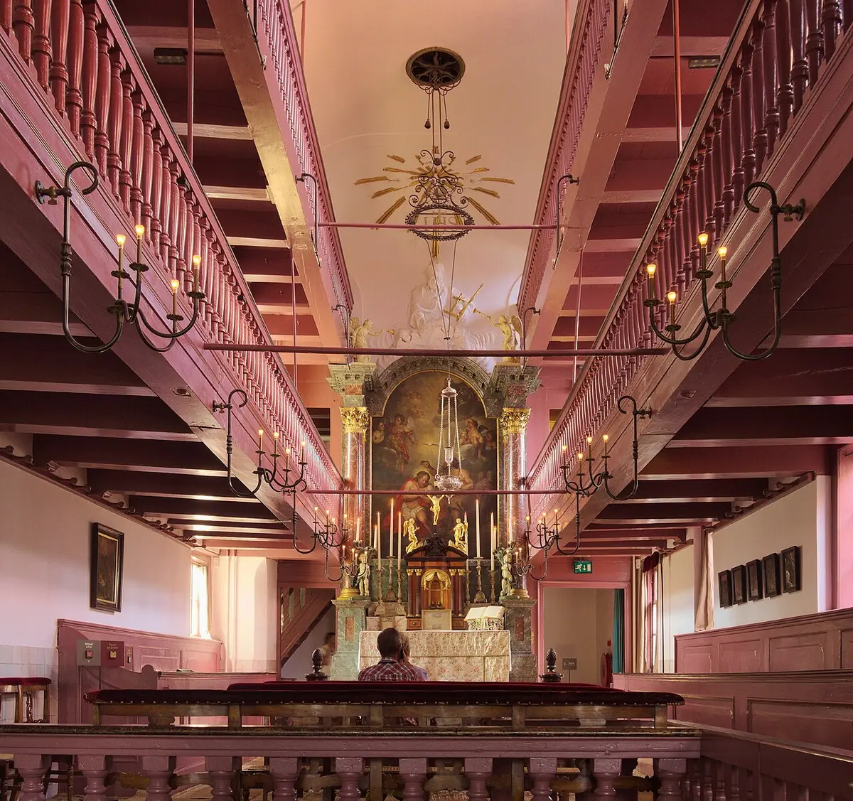 The attic church of Our Lord in the Attic, with galleries along both sides and the altar at the far end