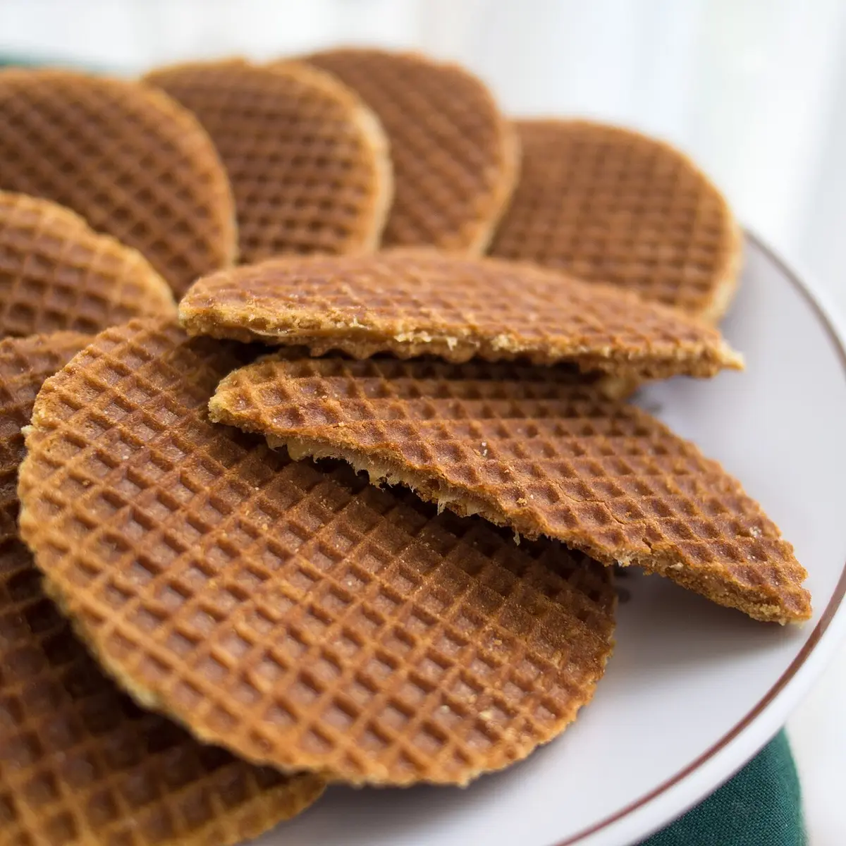 A plate of stroopwafels, thin waffles filled with syrup