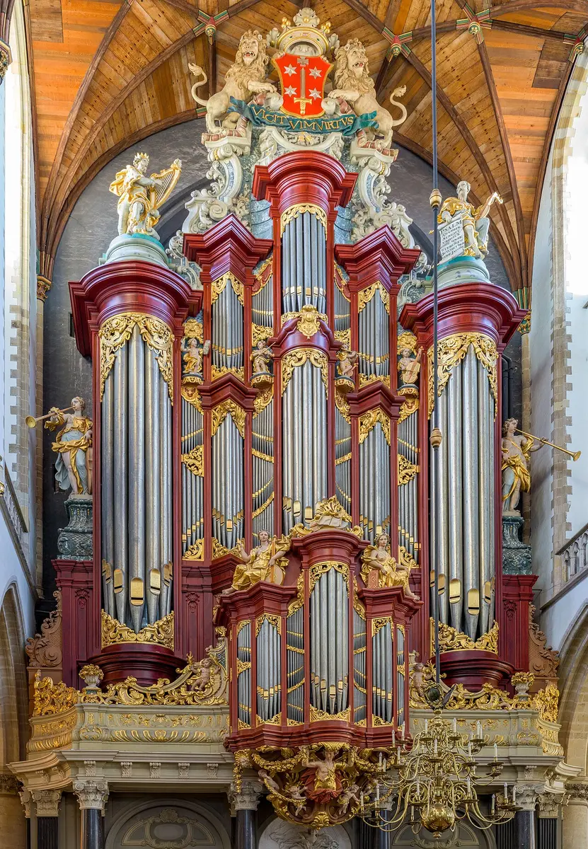The towering gilded organ case of St. Bavo in Haarlem, with red columns and carved figures