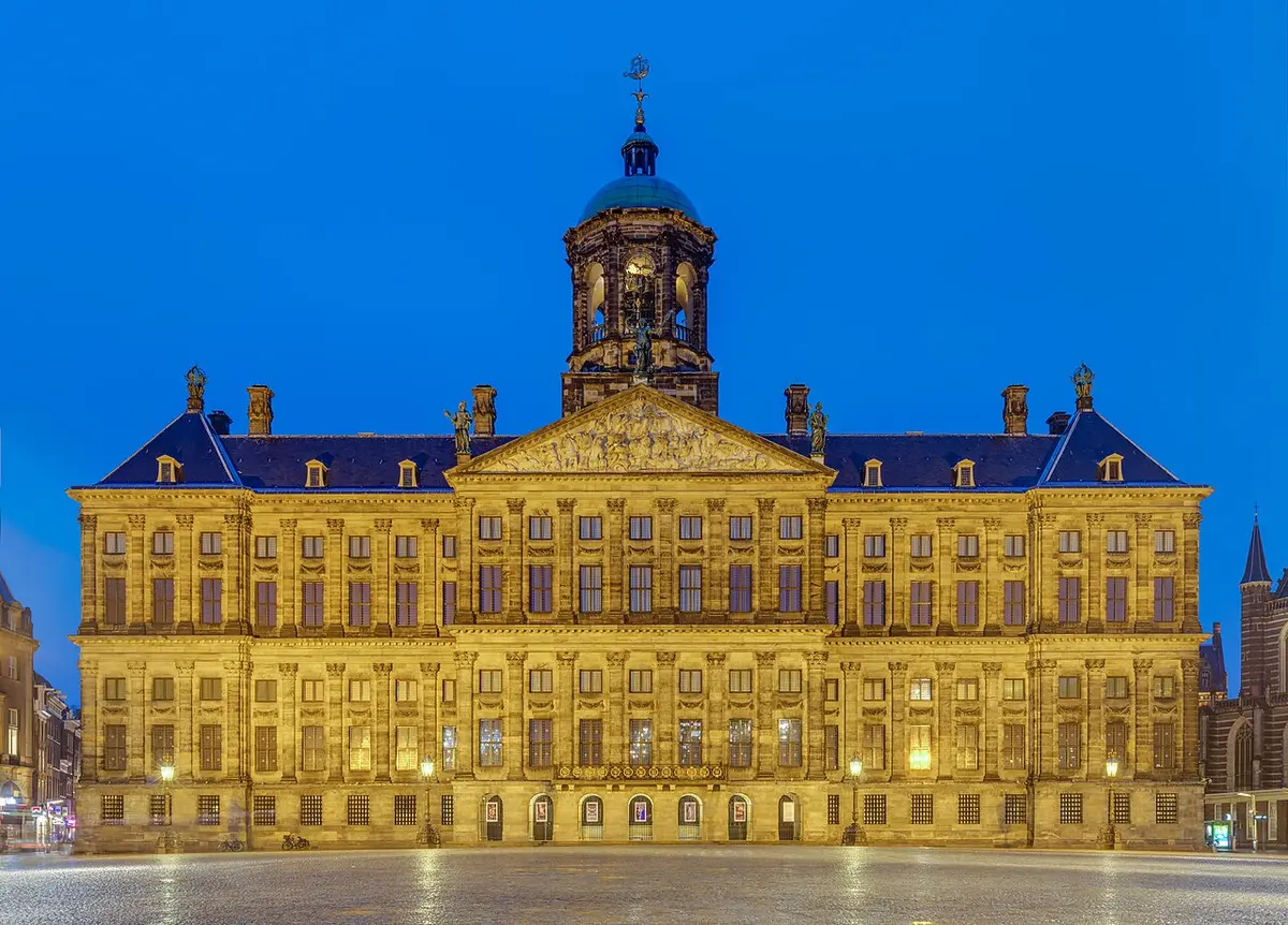 The Royal Palace on Dam Square lit up at dusk