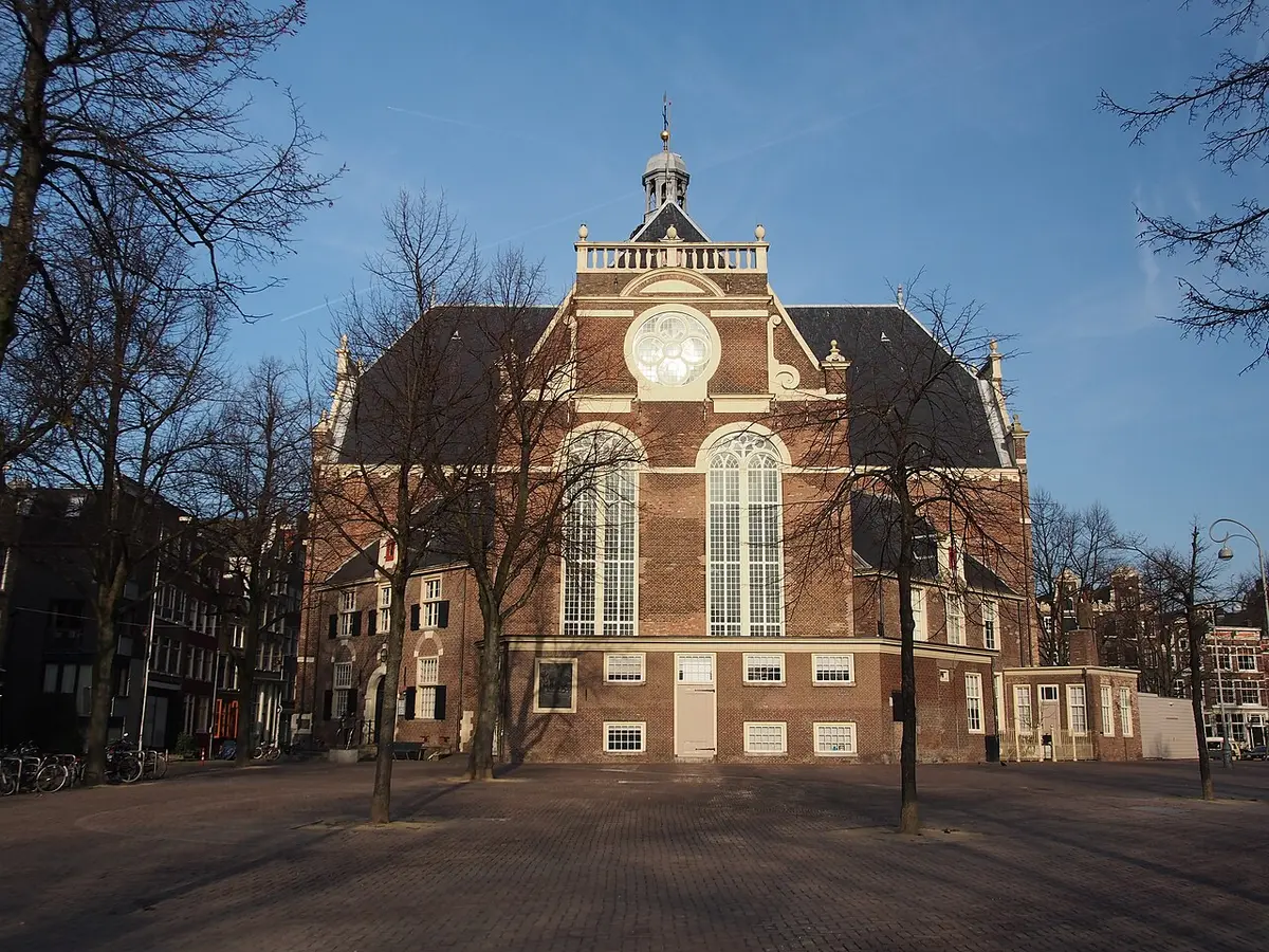 The brick Noorderkerk over the empty Noordermarkt square in evening light