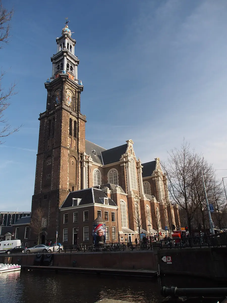 The brick Westerkerk and its tall tower in afternoon sun