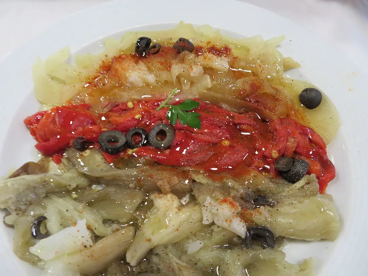 Roasted red peppers and aubergine dressed with olive oil and black olives