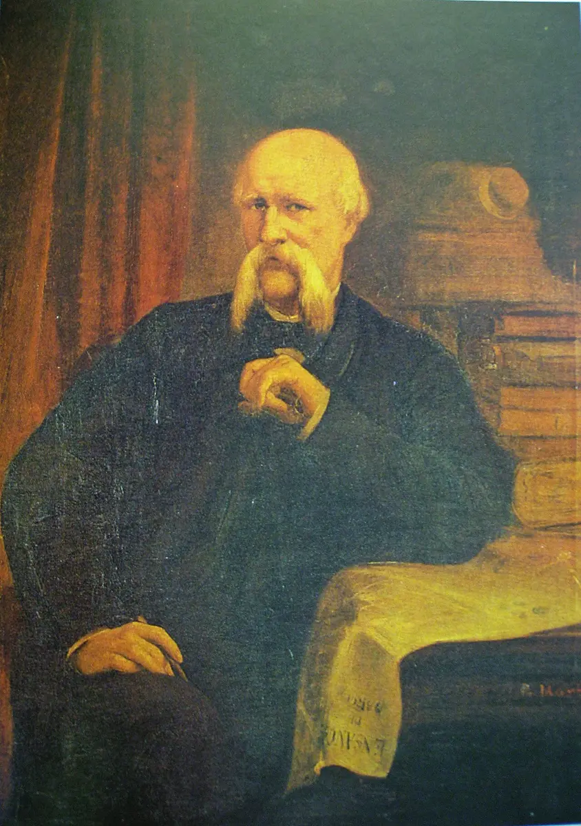 Portrait of Ildefons Cerdà, white-haired with a long mustache, seated in a dark coat