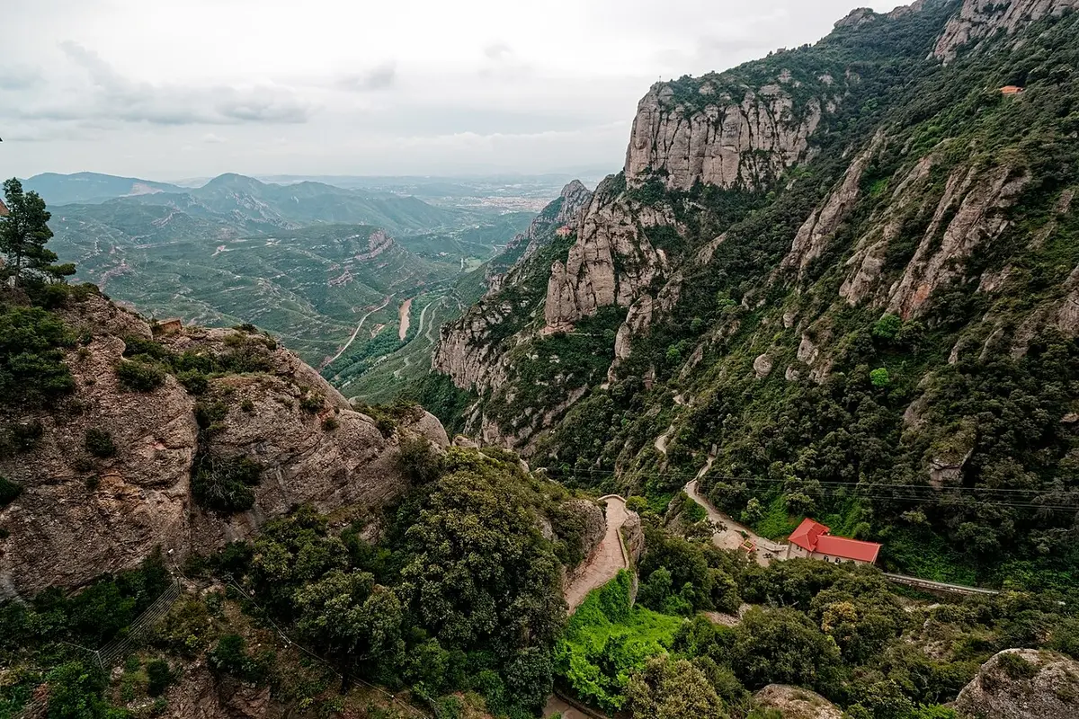 View from high on Montserrat over cliffs and wooded valleys toward the plain
