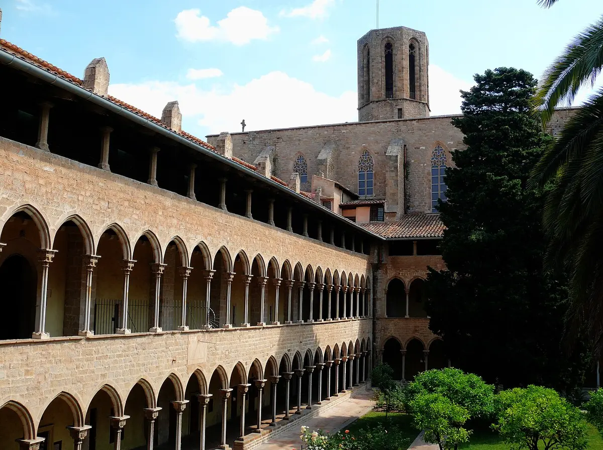 The three-story Gothic cloister of the Pedralbes monastery, with its bell tower behind