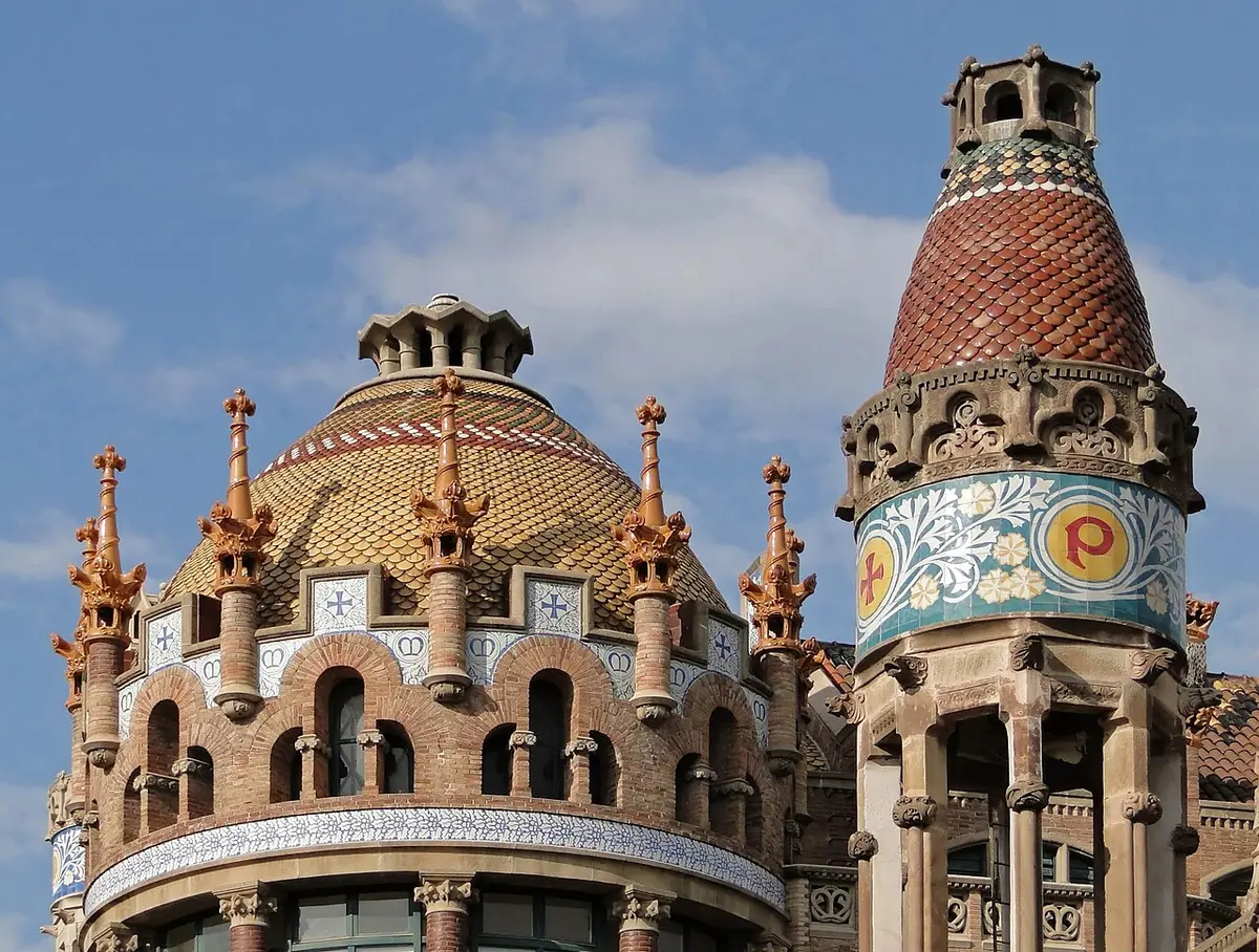 Tiled domes, a striped tower and pinnacles on one of the Modernista pavilions of Sant Pau