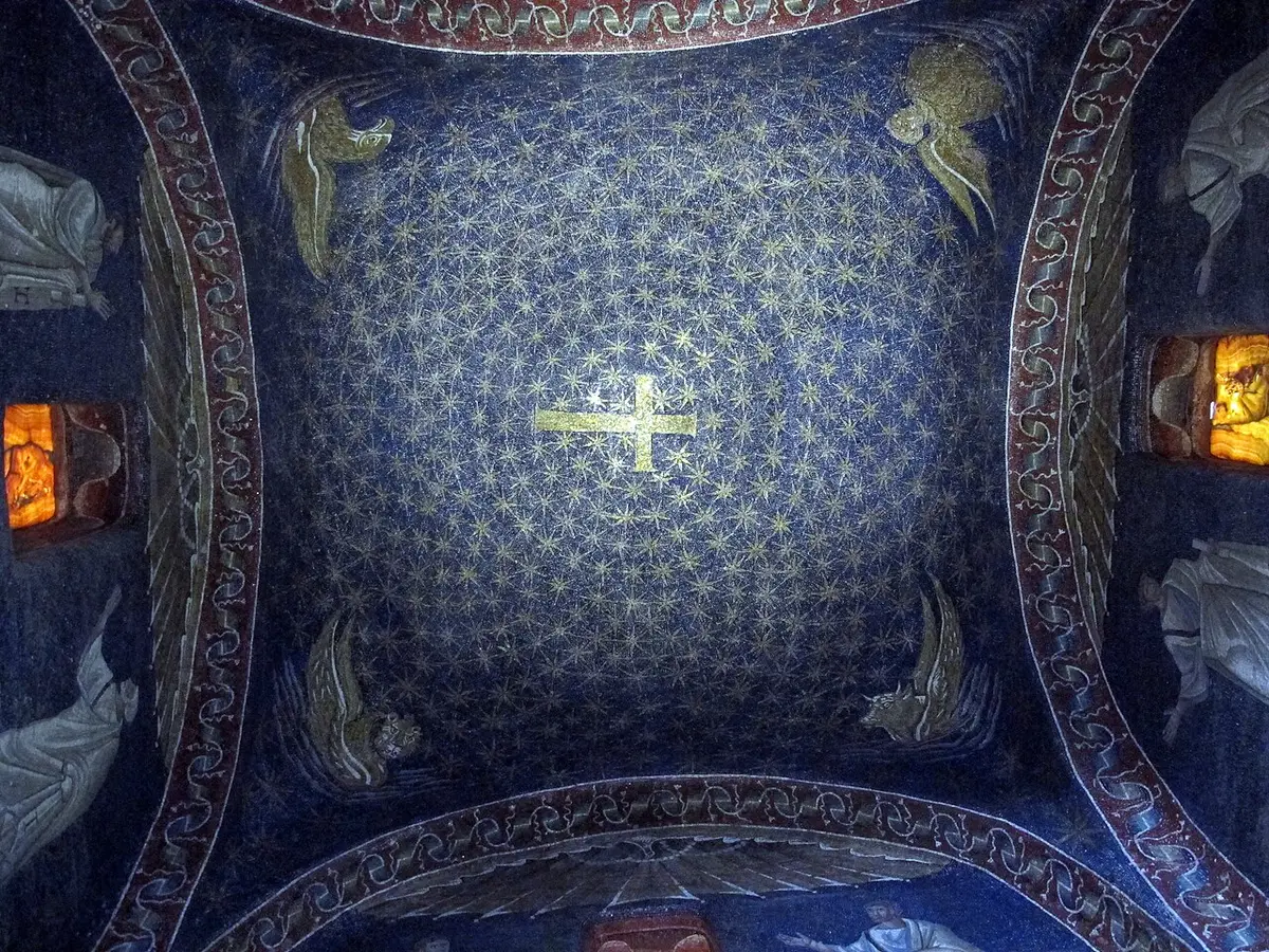 A mosaic dome of gold stars on deep blue around a gold cross, with winged figures in the corners