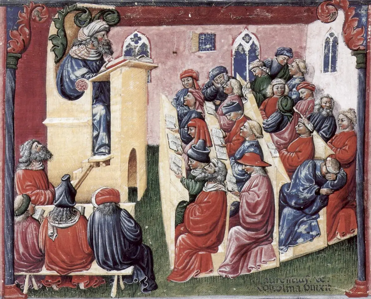 Medieval miniature of a bearded teacher at a raised lectern and rows of students with open books, some talking, one asleep