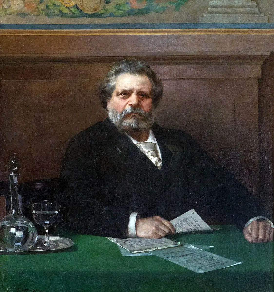 Painted portrait of Giosuè Carducci, gray-bearded, seated at a green table with papers