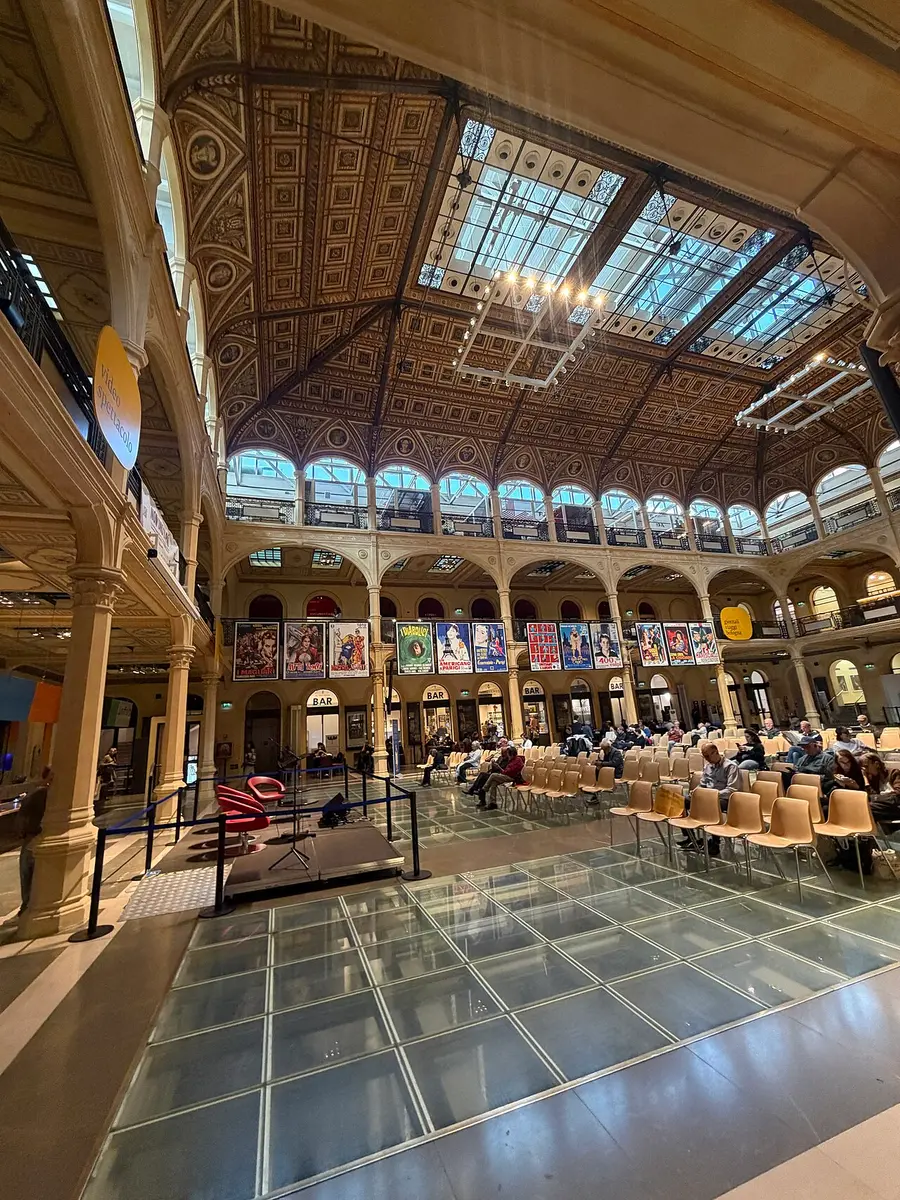 The great hall of the Salaborsa library under its glass roof, with a glass floor in front