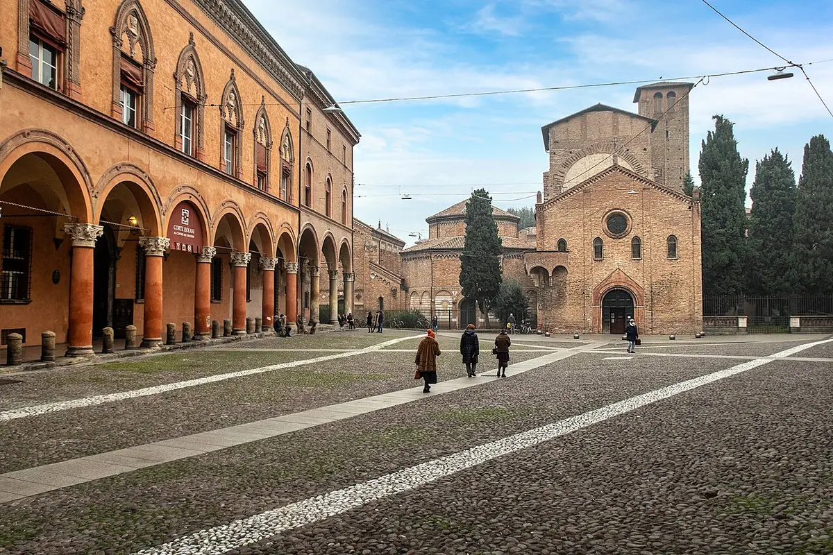 Piazza Santo Stefano with the brick churches of the Seven Churches at the end of the square and porticoes along one side