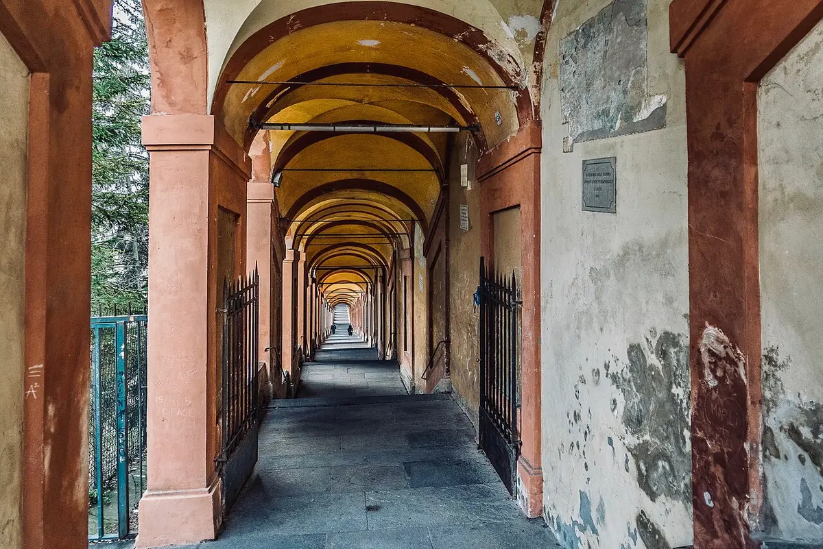 The San Luca portico running ahead in a long line of arches, with a plaque on the wall