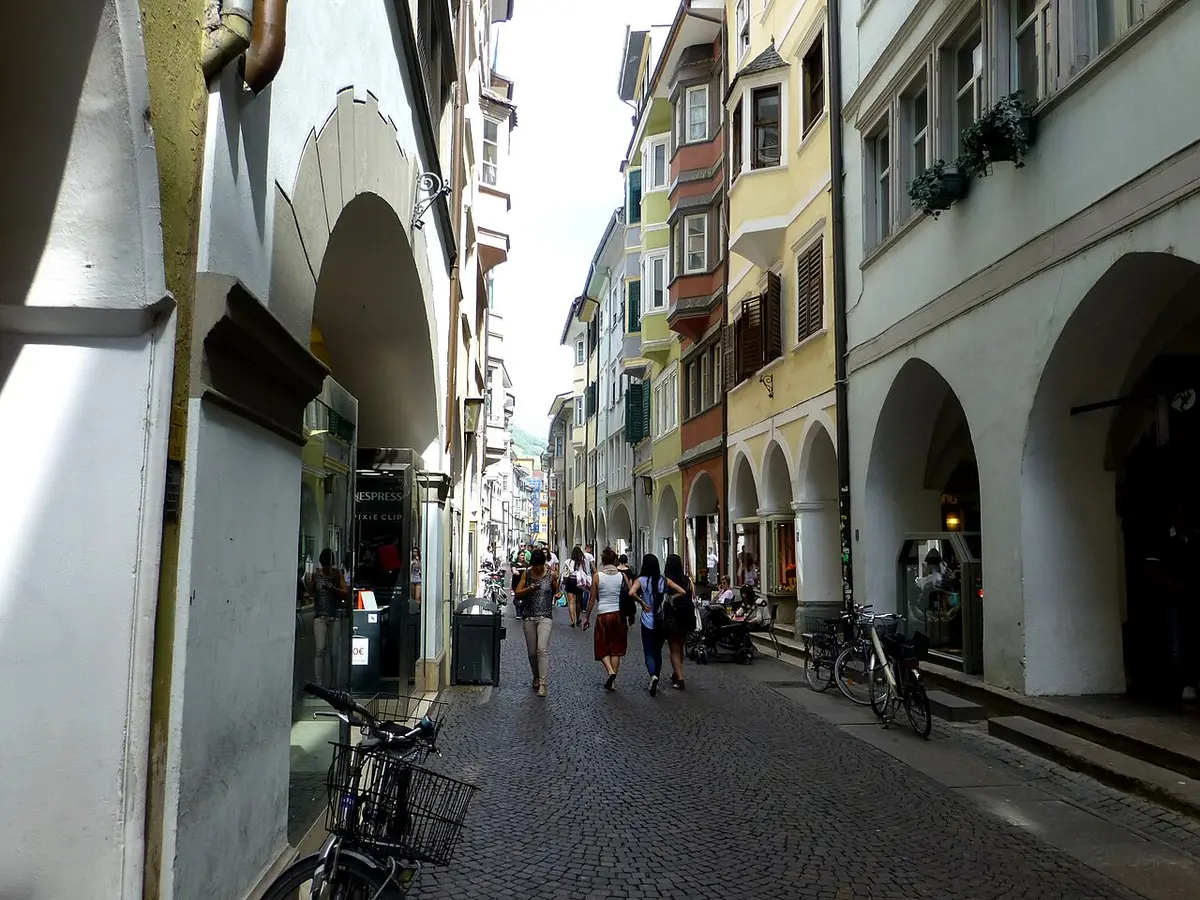 Via dei Portici, a cobbled street of arcades and tall houses with oriel windows