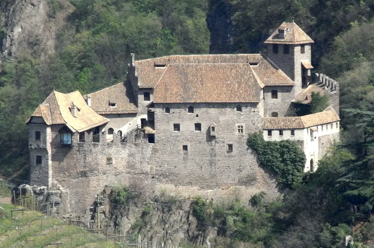 Runkelstein Castle on a rocky spur above a wooded gorge
