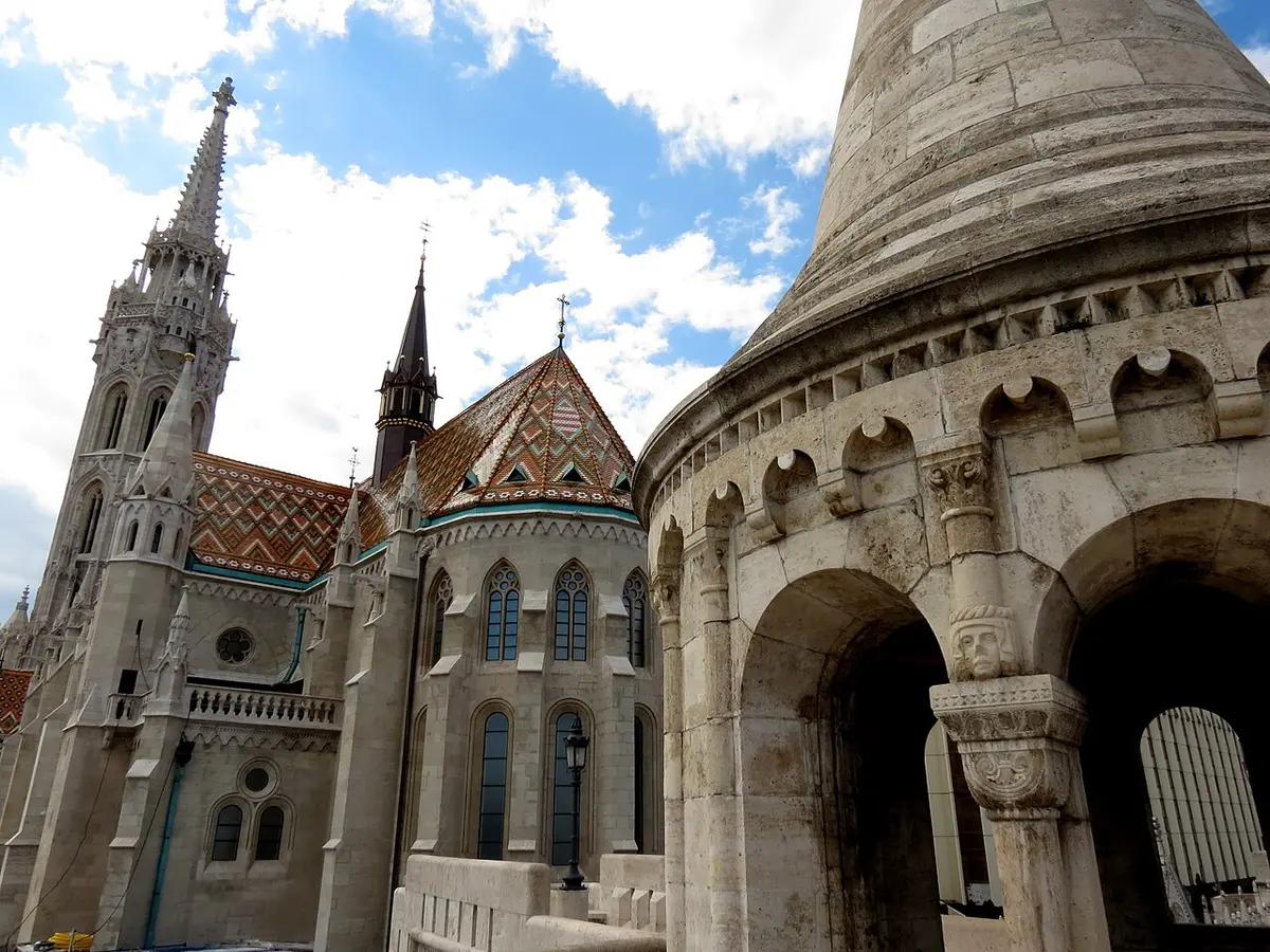 Matthias Church with its patterned tile roof and Gothic tower, beside a white turret of the Fisherman’s Bastion