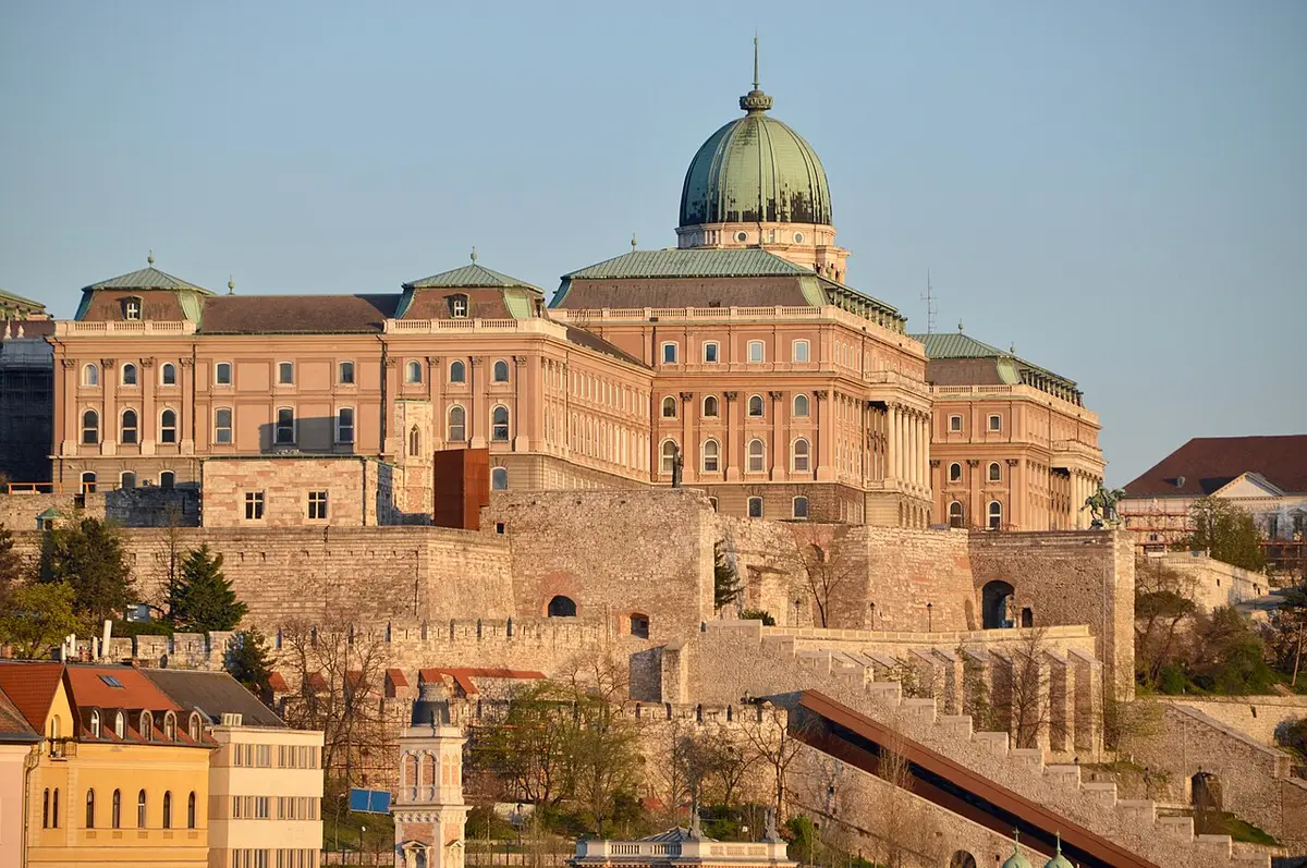 The Royal Palace of Buda Castle and its green dome in early morning sun, above the old walls