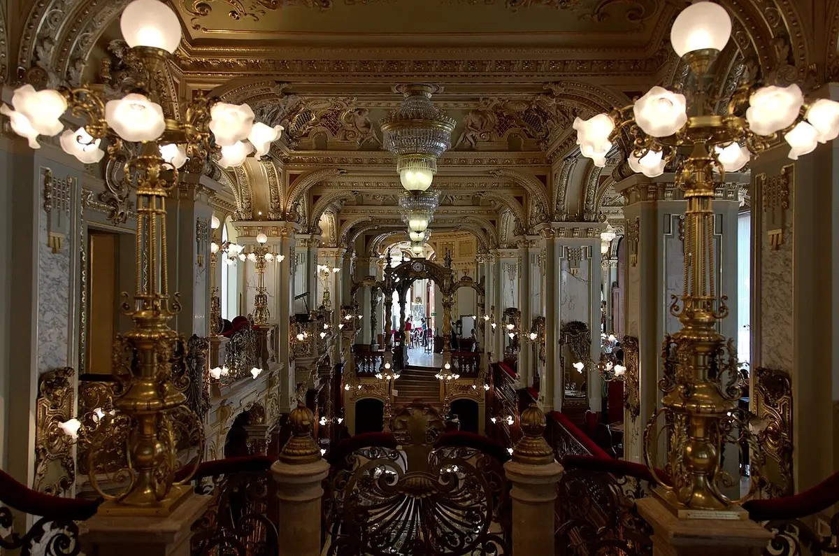 The gilded columns, twisted pillars and glowing lamps of the New York Café