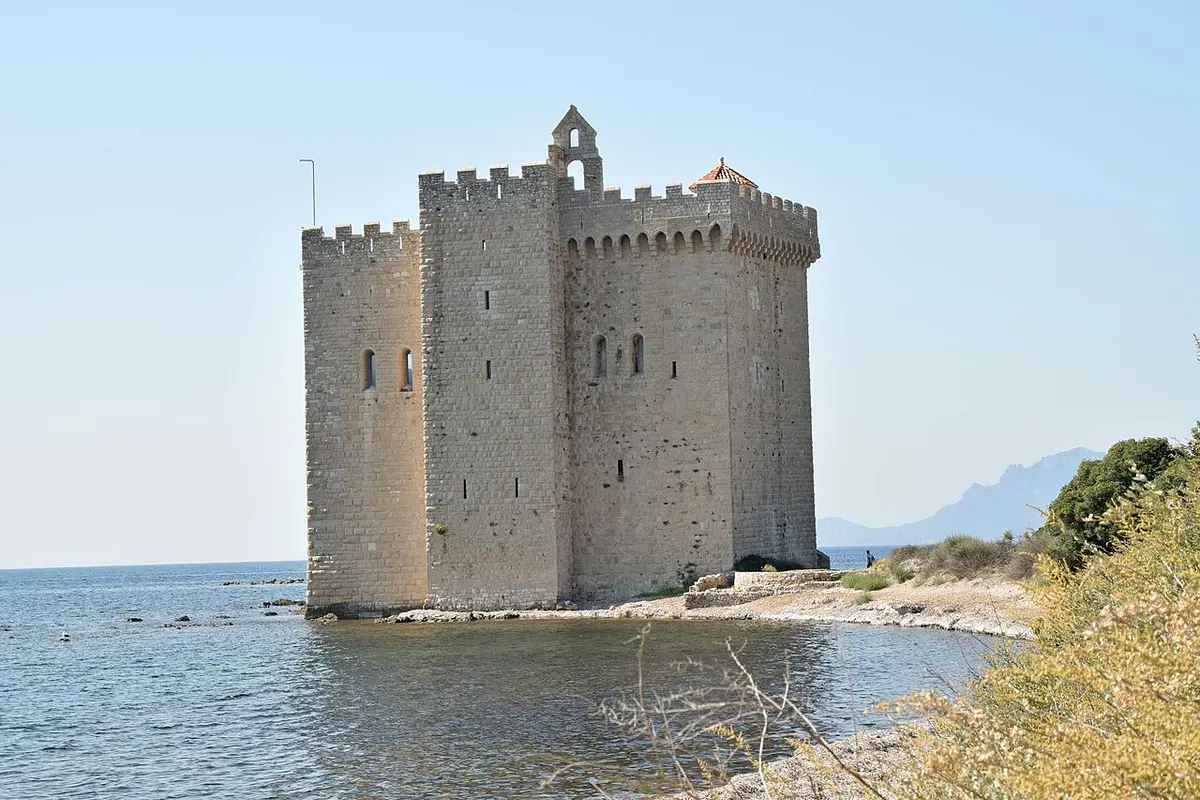 The square stone tower of the fortified monastery of Lérins rising from the sea off Île Saint-Honorat