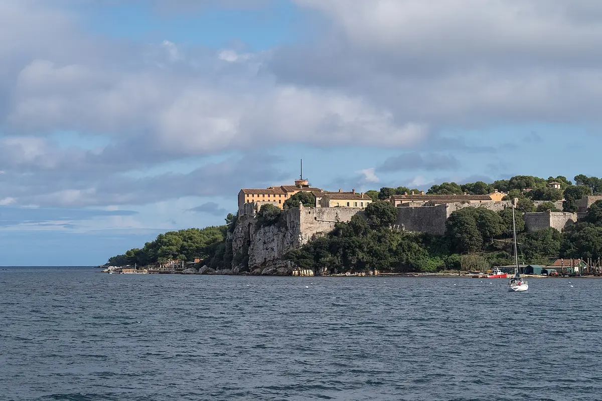 The walls of the Fort Royal on a wooded cliff of Île Sainte-Marguerite, seen from the sea