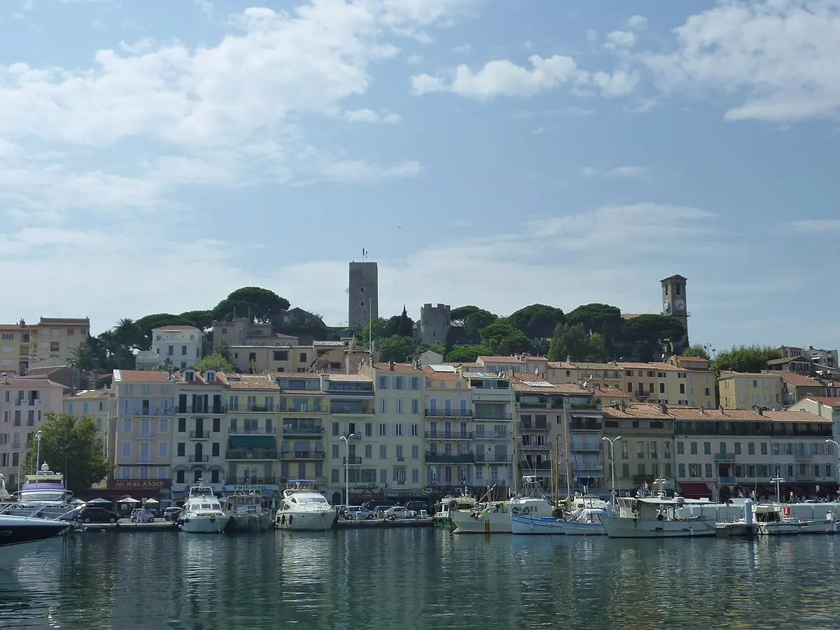 The old town of Le Suquet above the harbor, with the church and the square medieval tower on the hilltop