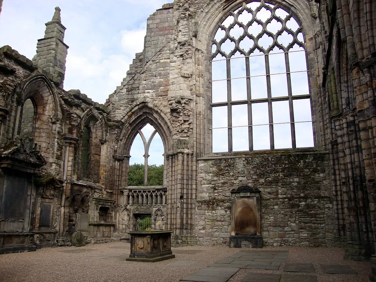 The roofless Gothic nave of Holyrood Abbey with a great empty east window