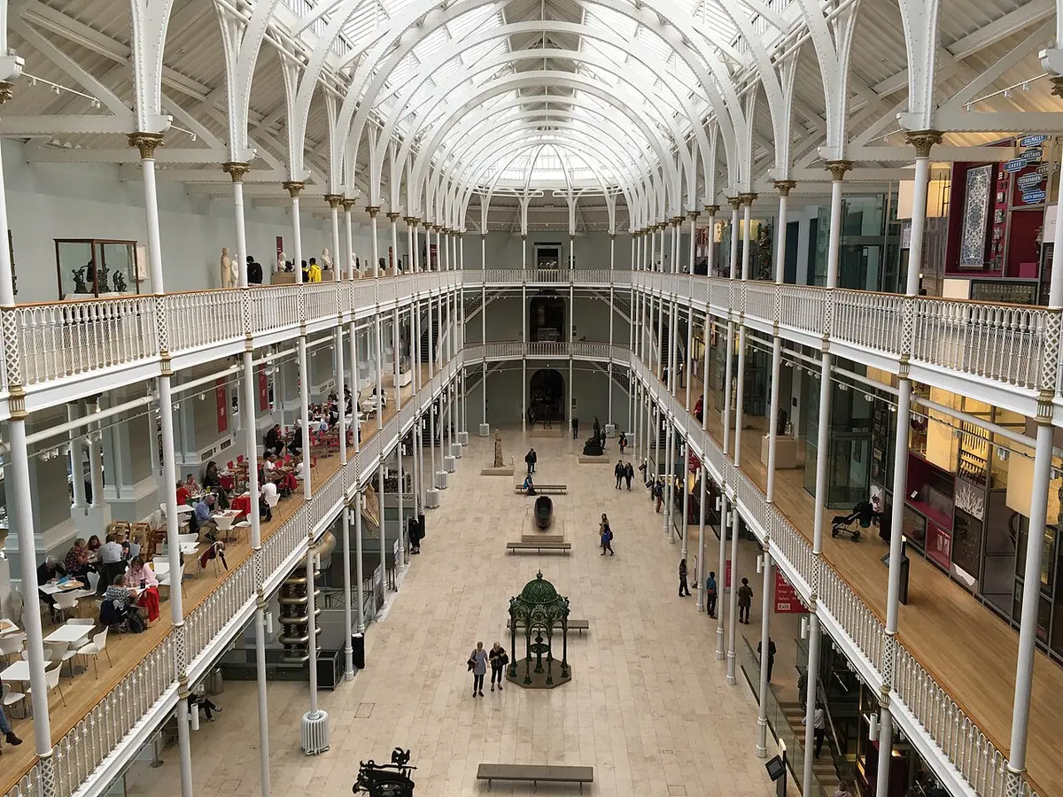 The white iron galleries and glass roof of the Grand Gallery at the National Museum of Scotland