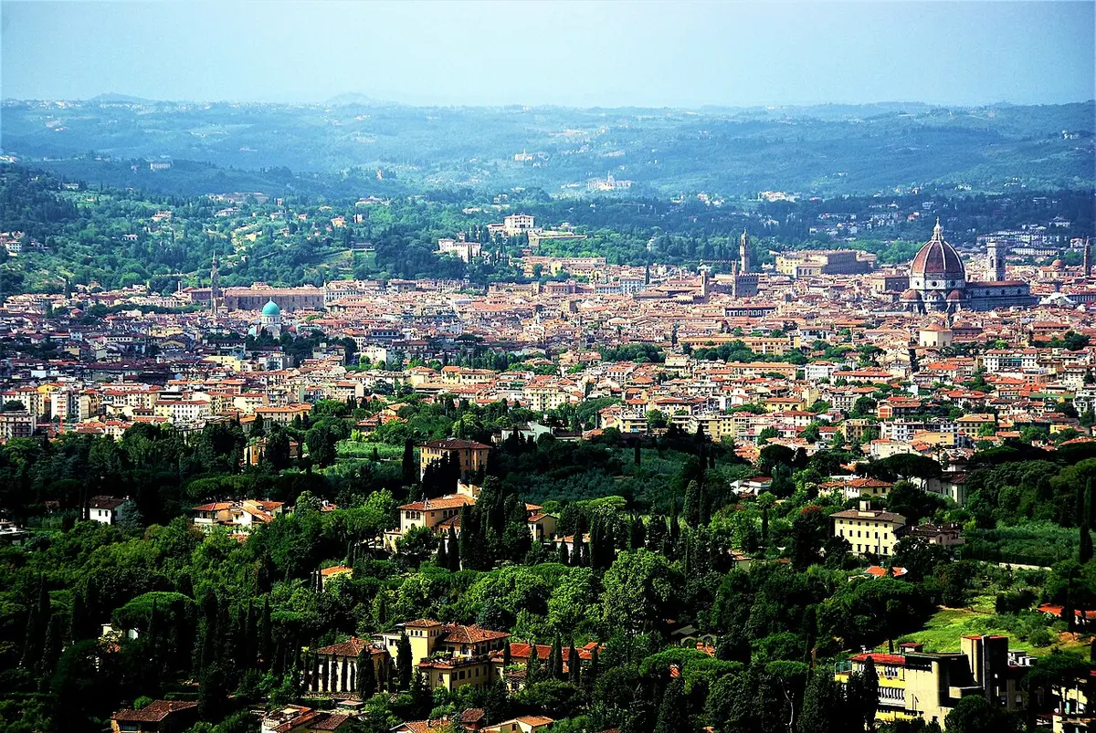 Florence seen from the hill of Fiesole, the cathedral dome and Palazzo Vecchio’s tower above the roofs and green hills around