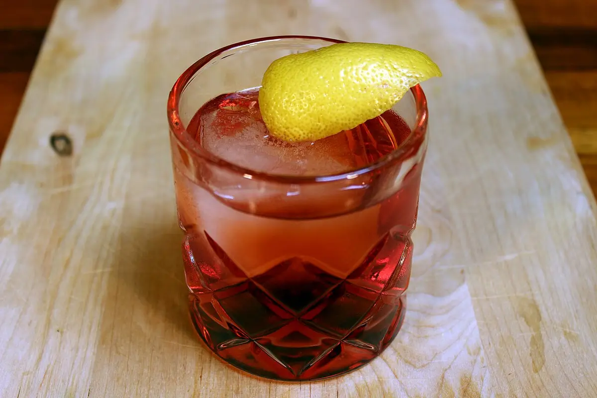 A Negroni on ice in a cut-glass tumbler with a twist of lemon peel