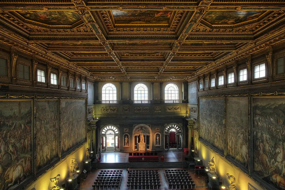 The Hall of the Five Hundred in Palazzo Vecchio, its walls covered with battle scenes under a gilded, painted ceiling