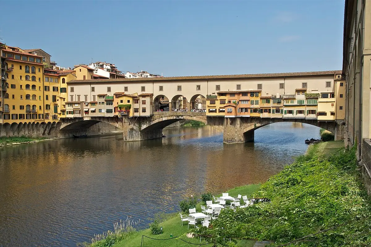 The Ponte Vecchio over the Arno, its three arches carrying a row of small shops and houses