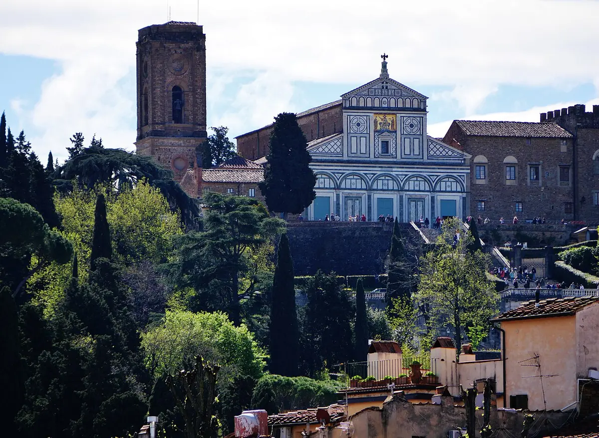 San Miniato al Monte, its white and green marble front and bell tower above cypresses on the hillside