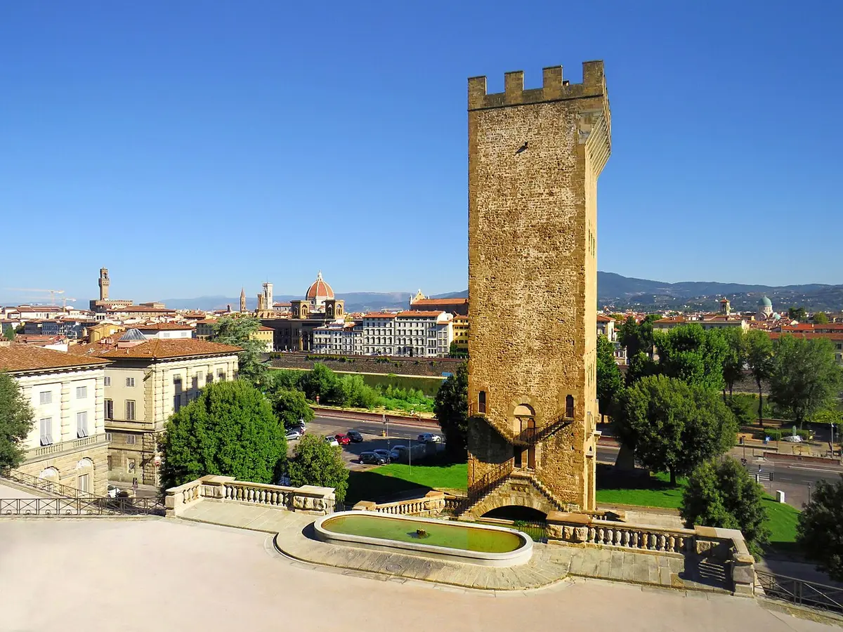 The tall stone tower of Porta San Niccolò on Piazza Poggi, the city across the river behind it