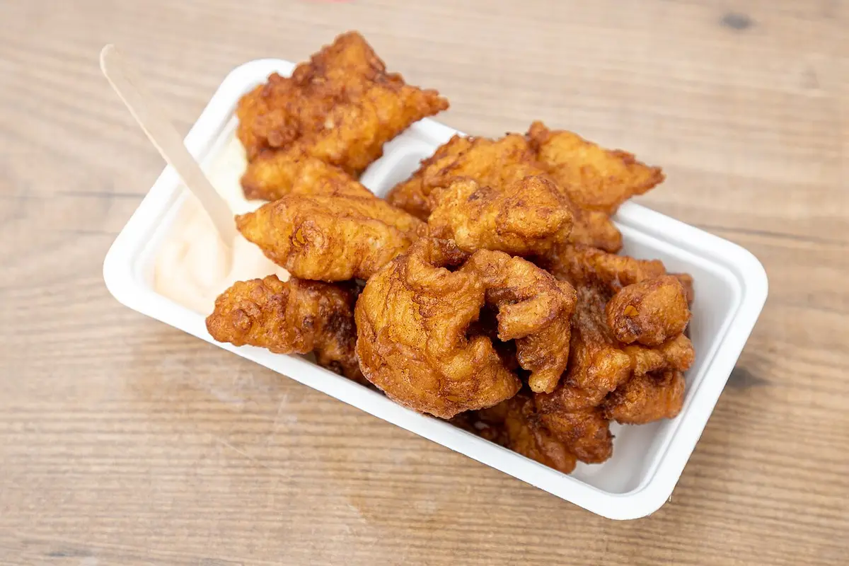 A paper tray of kibbeling, battered and fried pieces of white fish