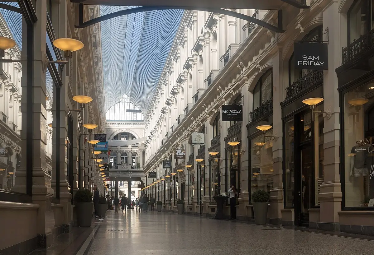 The glass-roofed Passage shopping arcade, lined with shopfronts and lamps