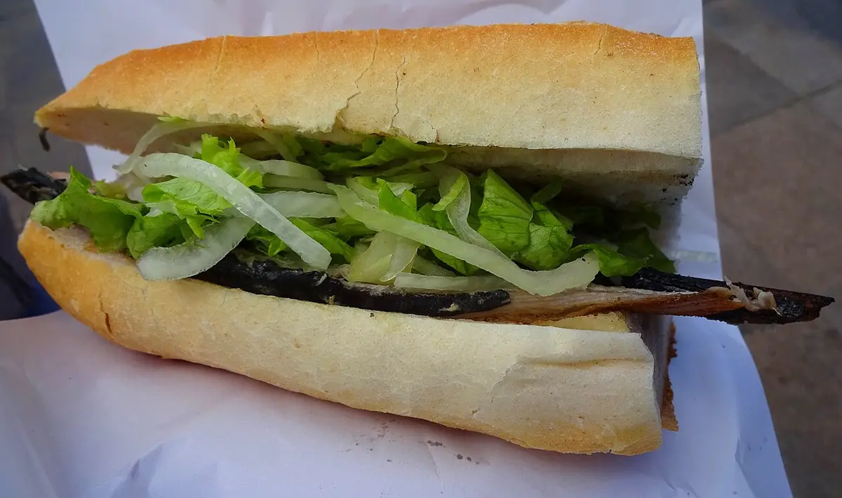 A balık ekmek: a fish fillet with lettuce and onion in a bread roll