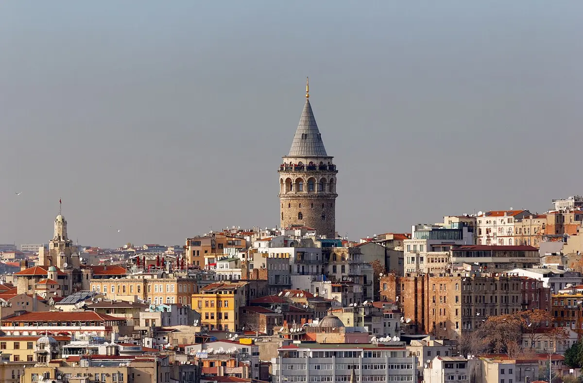 Galata Tower, a round stone tower with a pointed roof, rising above the rooftops of Galata