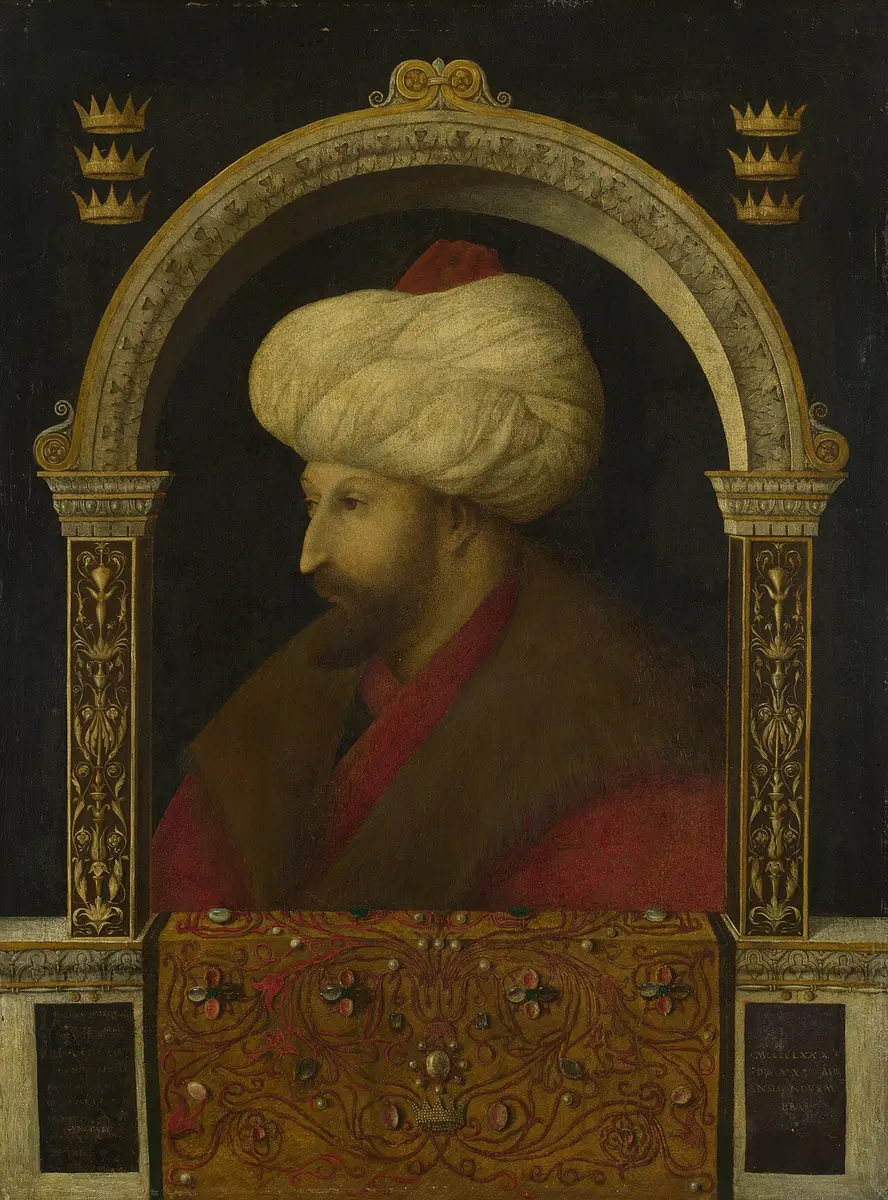Portrait of Mehmed II in profile, in a white turban and a fur-trimmed red robe, framed by a painted arch