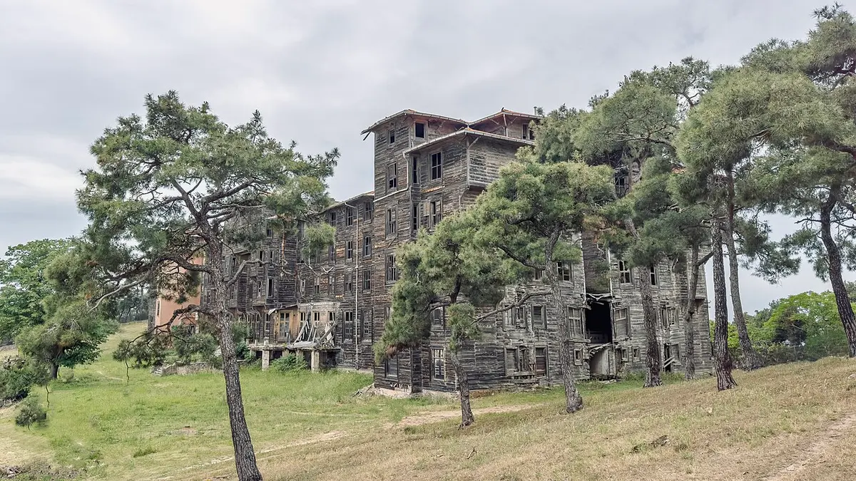 The huge dark wooden building of the former Prinkipo Greek Orthodox Orphanage among pine trees