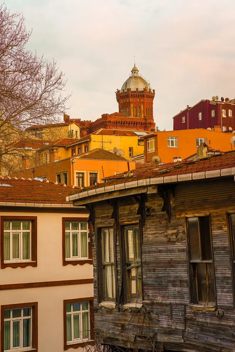 The domed tower of the red-brick Phanar Greek Orthodox College rising above old houses in Fener