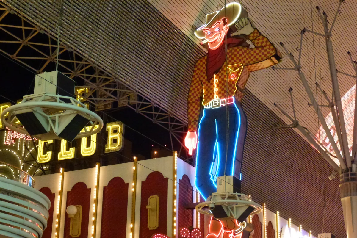 Vegas Vic, a giant neon cowboy with a raised hand, above the old Pioneer Club under the canopy of Fremont Street