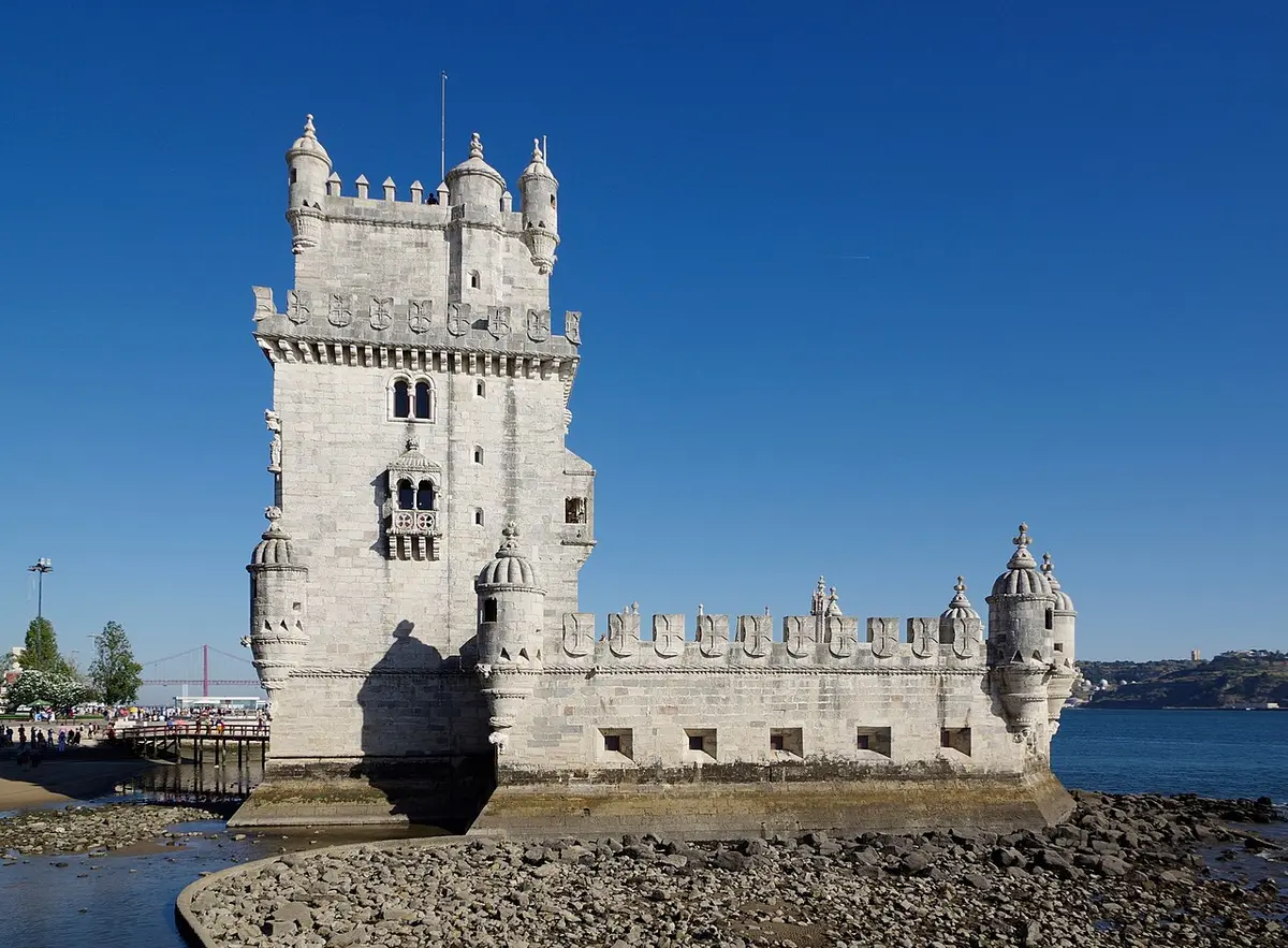 Belém Tower, a white stone fortress with turrets, at the edge of the Tagus