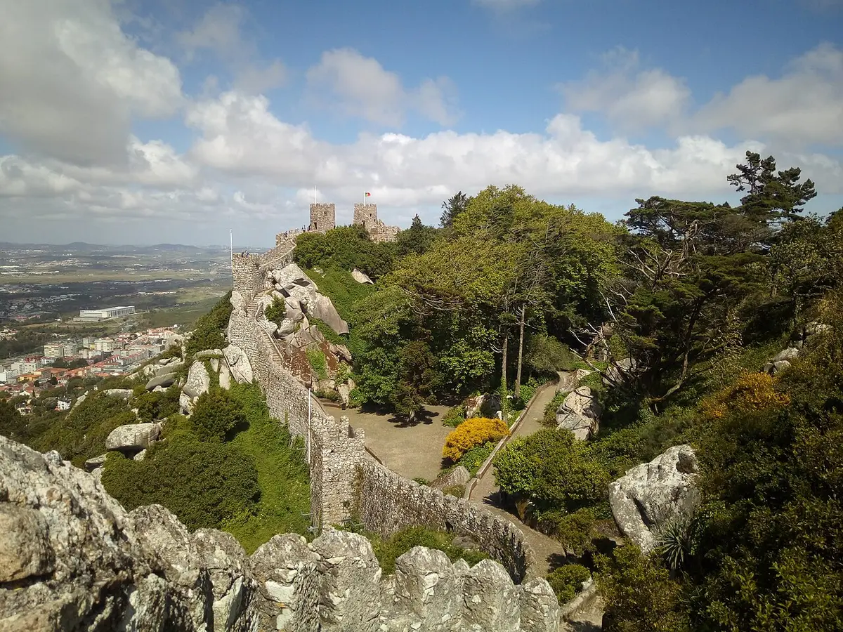 The walls of the Moorish Castle running along a wooded ridge above Sintra