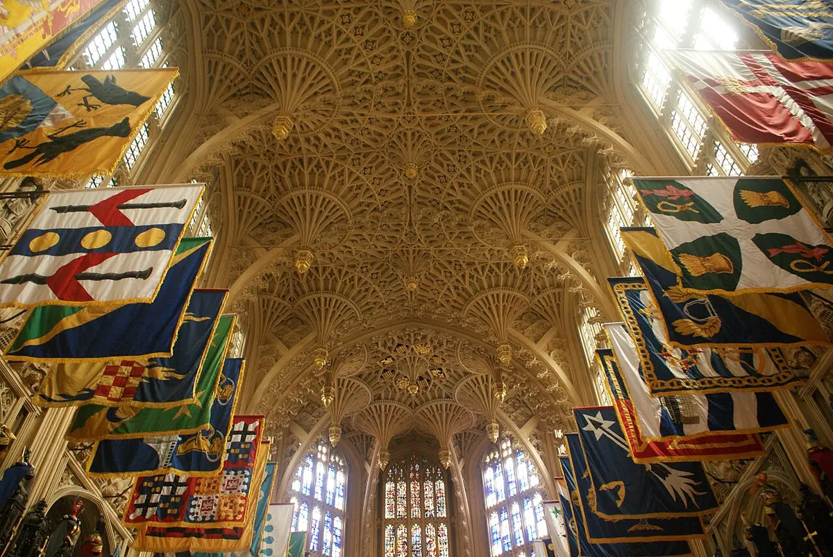 The fan-vaulted stone ceiling of the Lady Chapel in Westminster Abbey, with knights’ banners along the walls