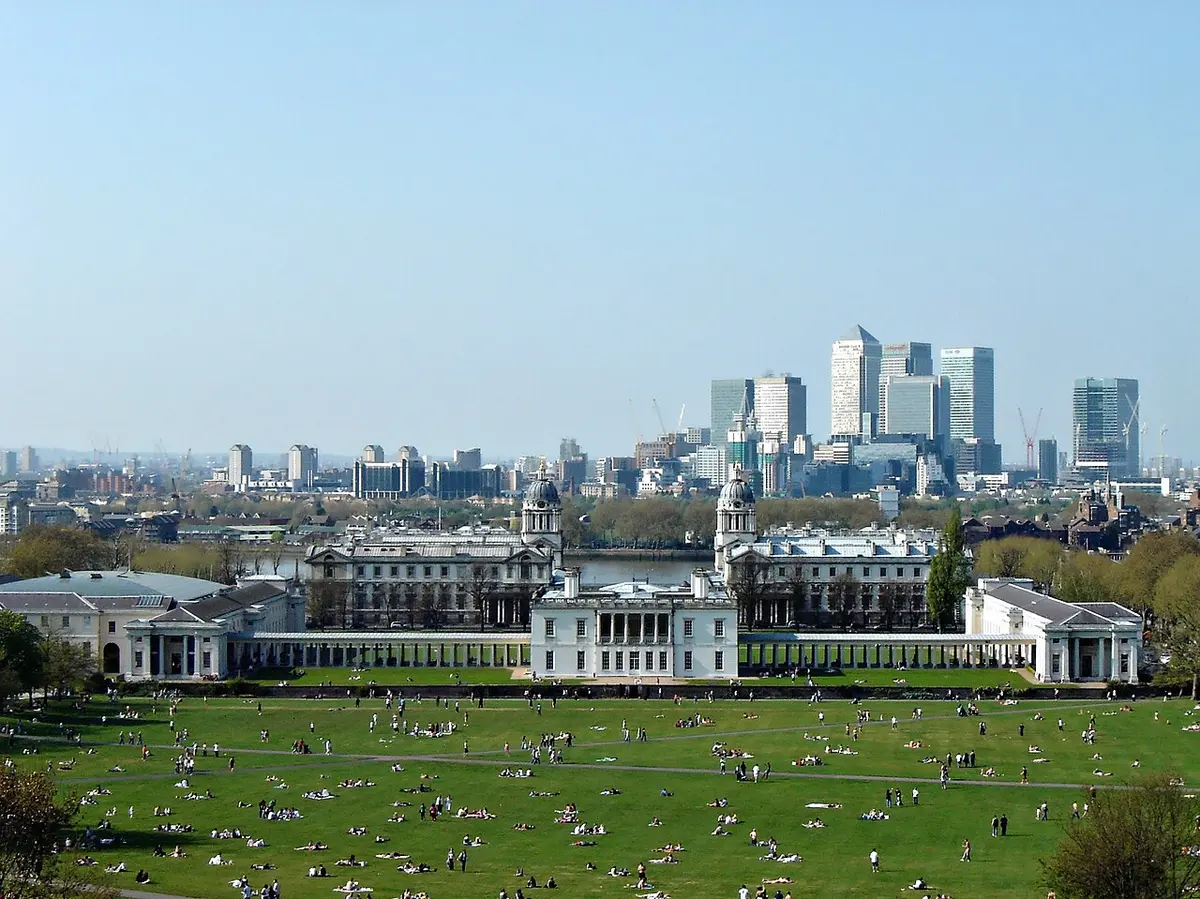 The white Queen’s House and the Old Royal Naval College below Greenwich Park, with the towers of Canary Wharf across the river