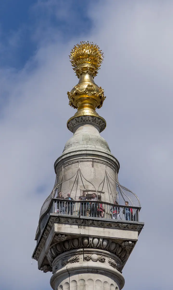 The gilded urn of flames at the top of the Monument, above a caged viewing gallery