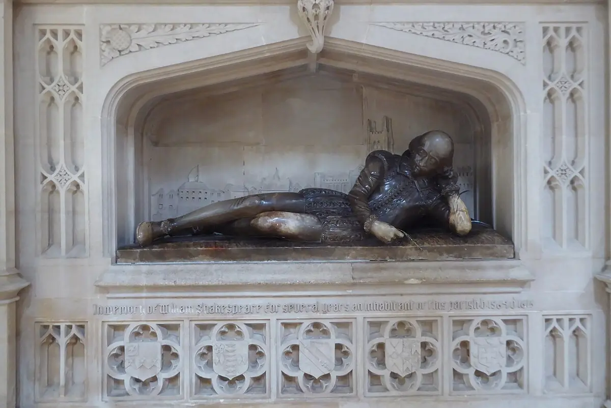 A reclining alabaster figure of Shakespeare in a carved stone niche