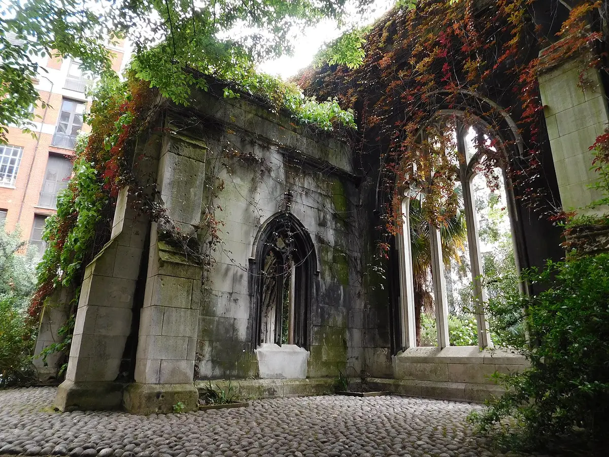 Gothic windows in the ruined walls of St. Dunstan-in-the-East, overgrown with creepers