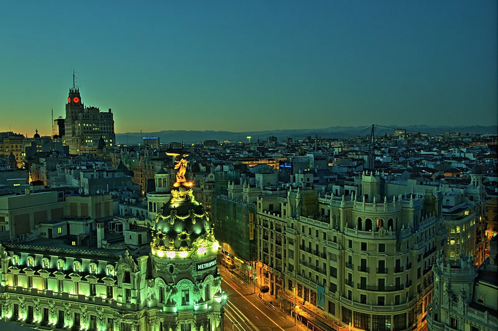 Gran Vía at dusk from the roof of the Círculo de Bellas Artes, with the lit dome of the Metrópolis building in front